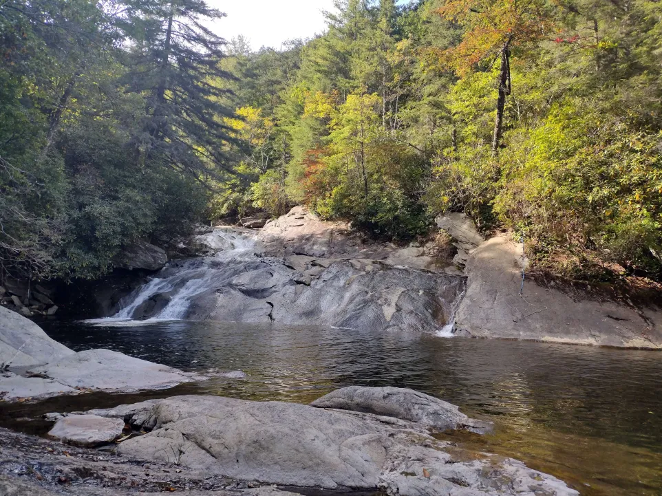 A mountain river, with a side of rock where a waterfall resided. 
