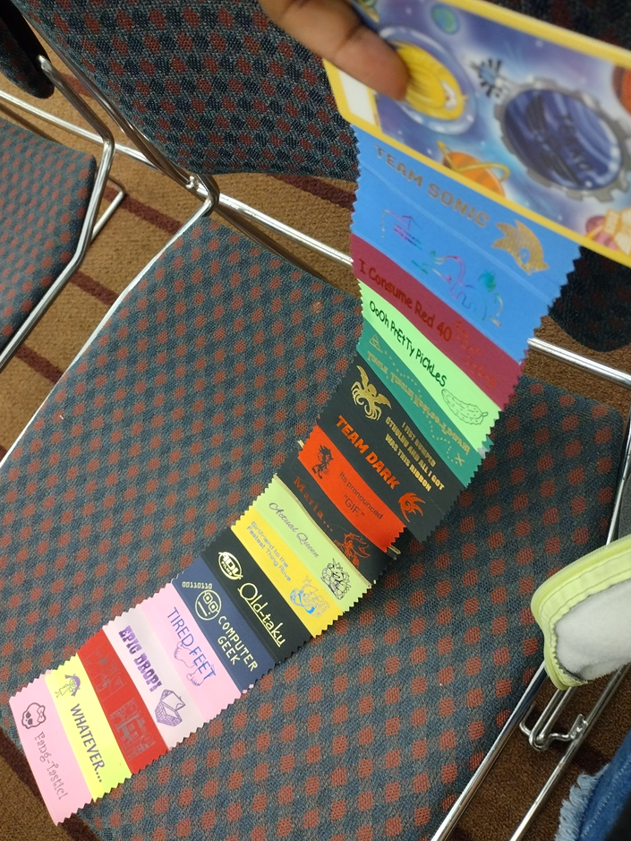 Some ribbons I began collecting that night, about 18 of them taped together and hanging off my convention badge.