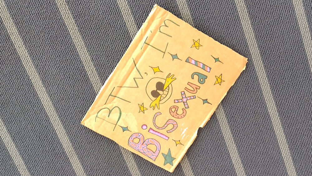 A cardboard sign with Eggman's face declaring "BTW, I'm bisexual."