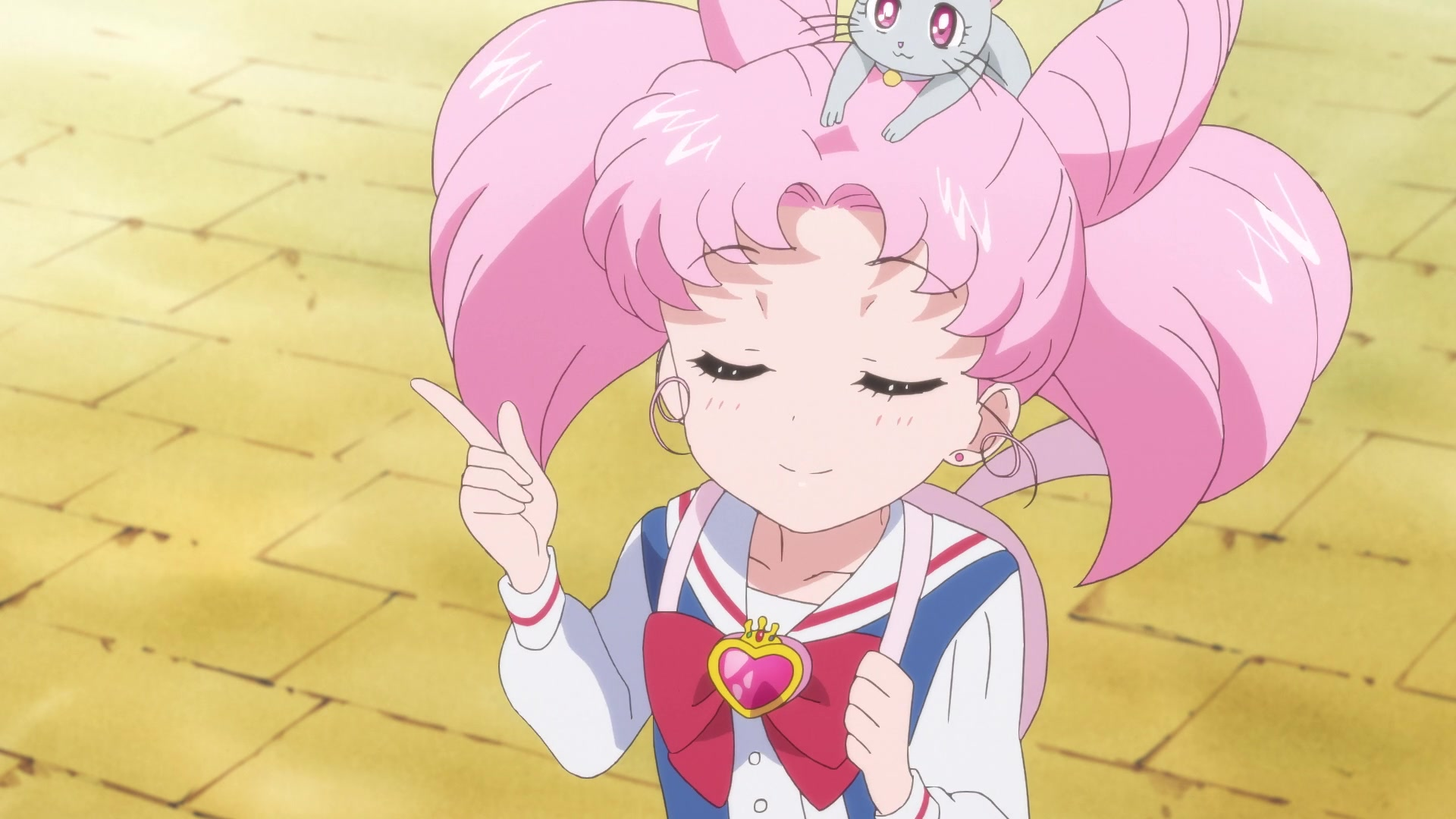 Chibi Usa, in her civilian kid-to-school uniform, is mid-smug about something while Diana (smol grey kitten) hangs out atop her head.