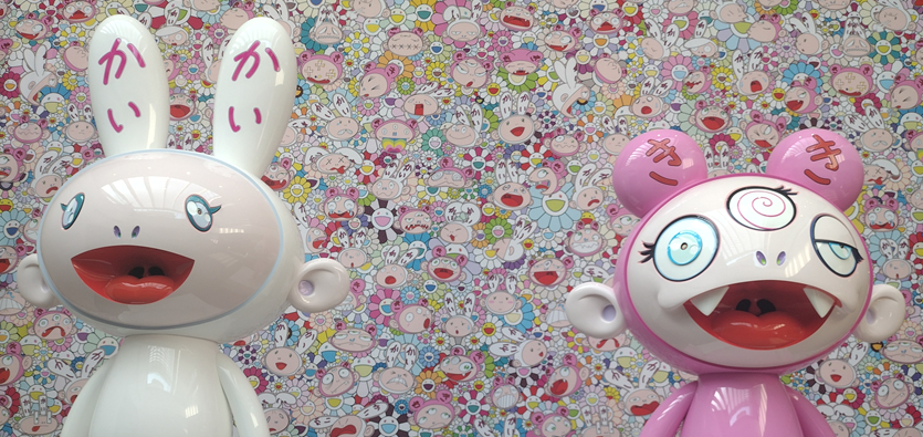 Takashi Murakami's two statues of poppy, whimsical art styled cartoon characters.