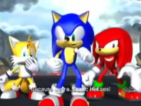 Tails, Sonic, and Knuckles standing as Sonic declares, "Because we're... Sonic Heroes!" This is a still from the Sonic Heroes game.