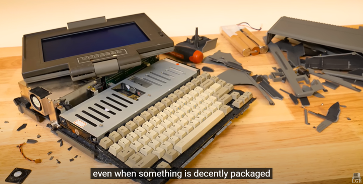 A vintage computer (1986 HALiCAN) with their fragile casing in shambles. You can see the internals with bits of plastic everywhere.