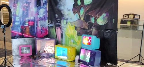 A photobooth setup, that's cyberpunky with a lot of neon.