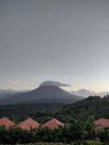 The volano in the distance at dusk, with a cloud covering the top of it. Aww, man. 